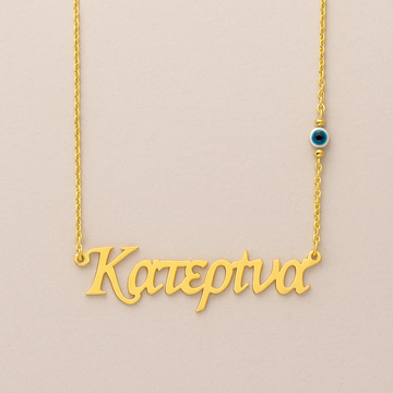 Gold necklace with 'Katerina' pendant on a beige background