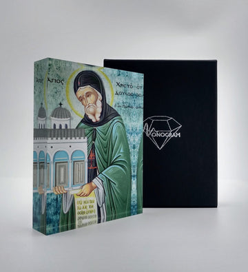 An icon of Saint Chrystodoulos, depicted in a vibrant painting with a 3D effect, placed in a black frame with a diamond-shaped logo on the front.