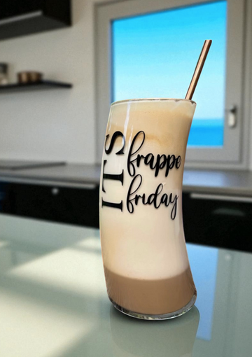 Glass of frappe with 'frappe friday' text on a kitchen counter