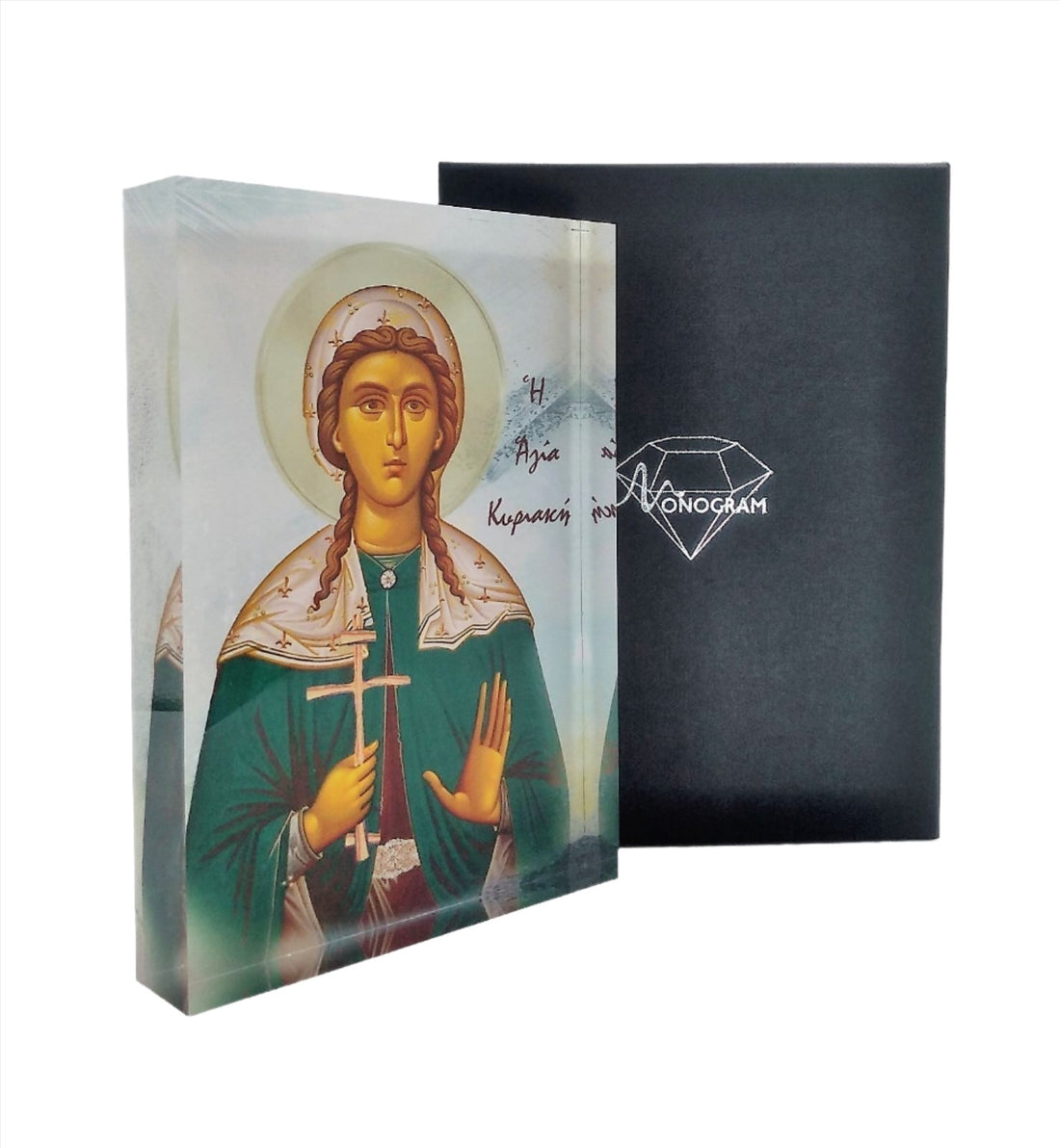 An icon of Saint Kiriaki with a 3D effect, displayed on a stand, with a black background and a diamond-shaped logo on the right side.