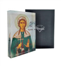 An icon of Saint Kiriaki with a 3D effect, displayed on a stand, with a black background and a diamond-shaped logo on the right side.