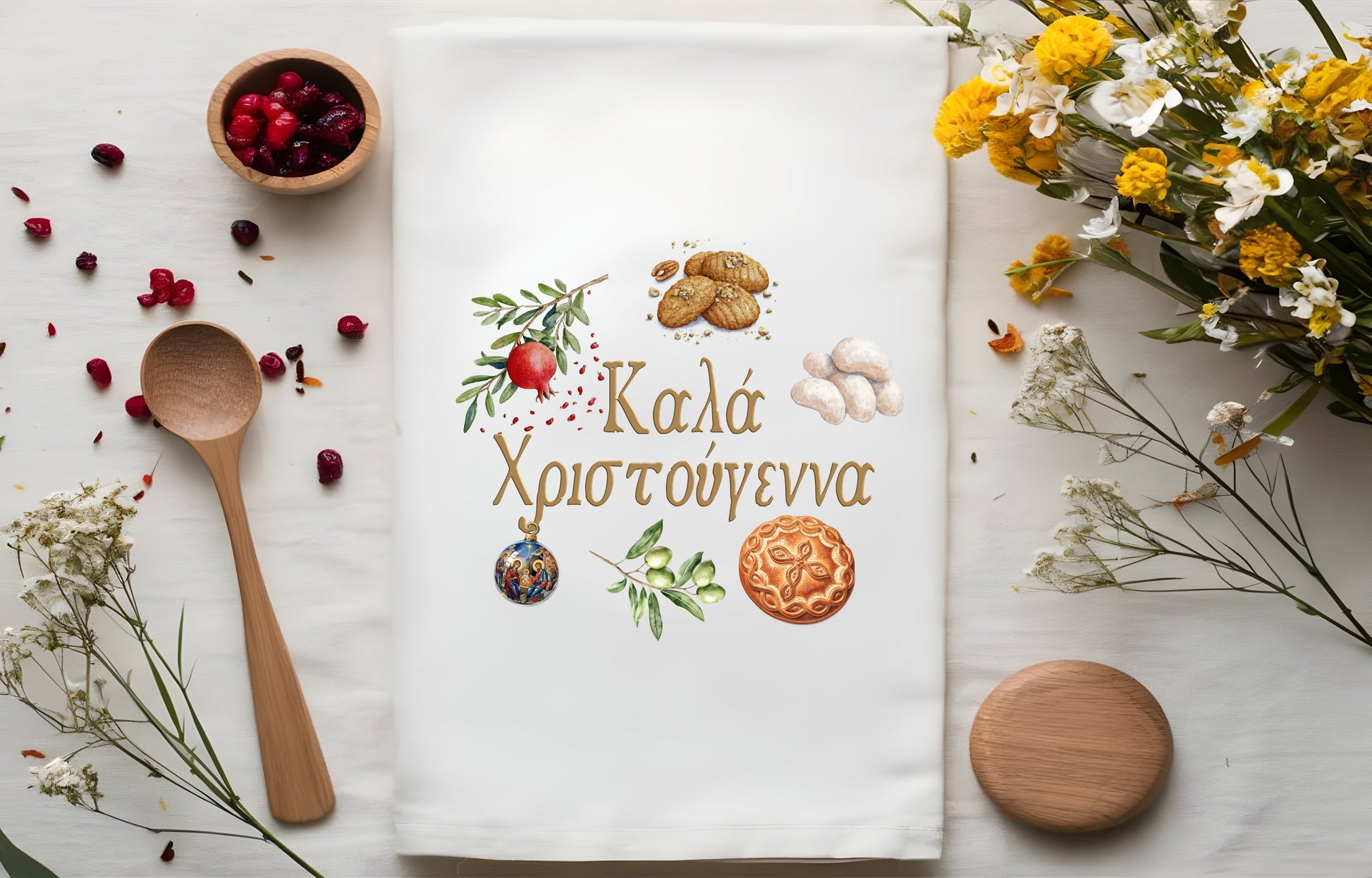 Decorative tea towel with Greek festive design and text, surrounded by Greek Sweets