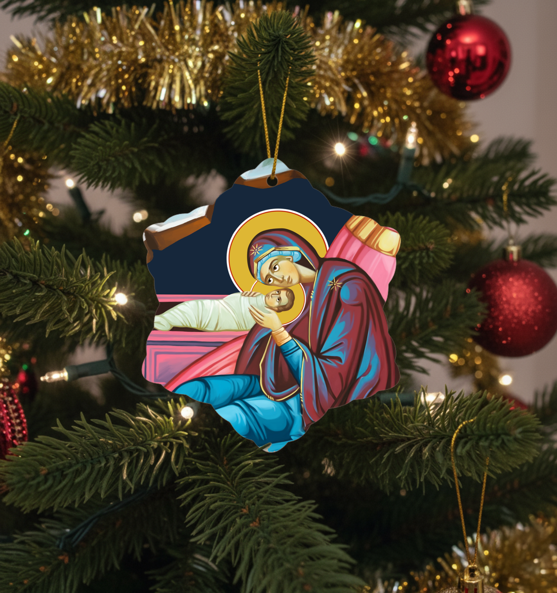 Decorative Christmas ornament of the Nativity scene on a Christmas tree.