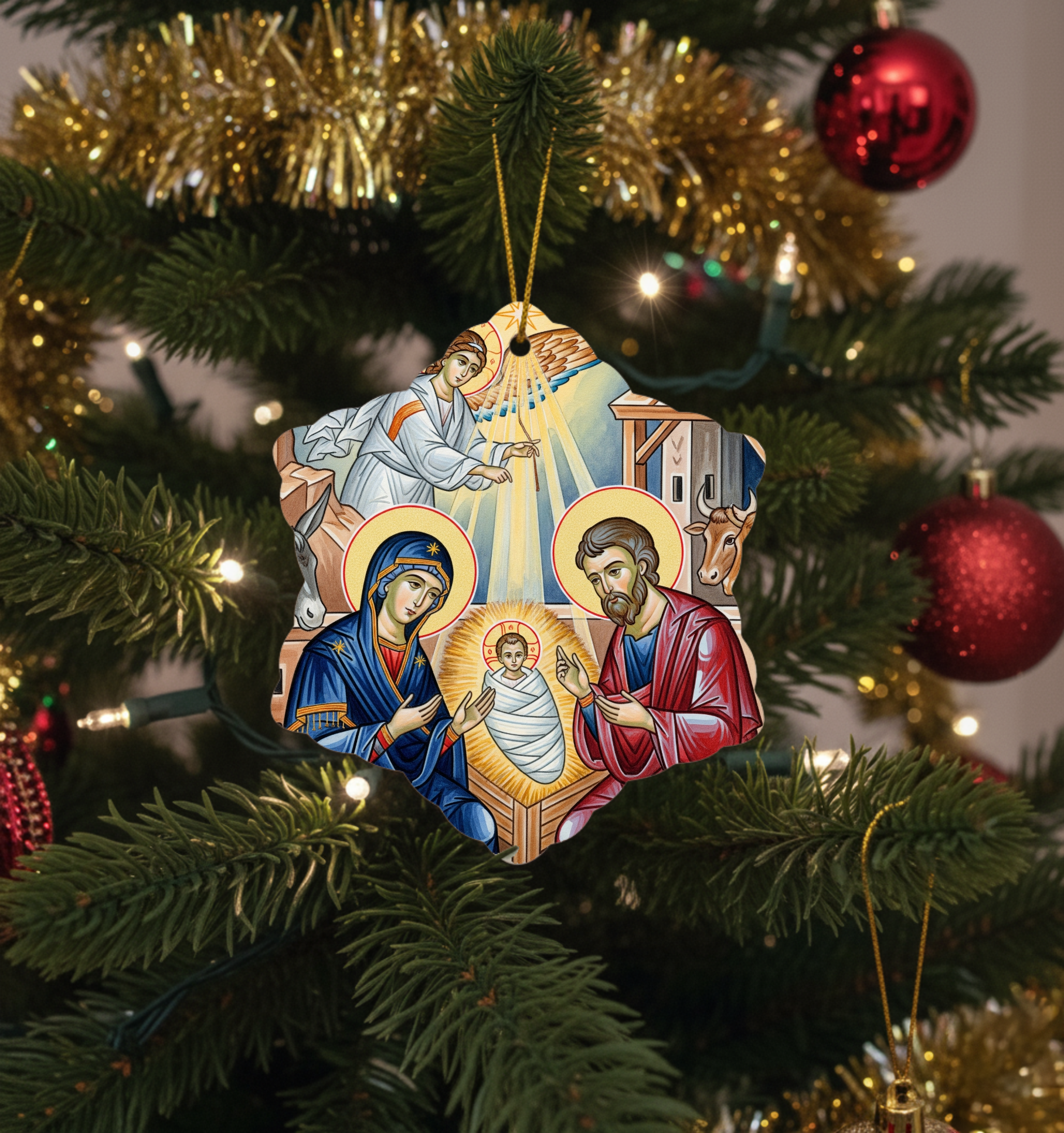 Decorative Christmas ornament with religious scene on a Christmas tree.