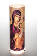 Decorative candle with an image of a religious icon on a beige background