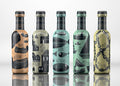 Six collectible Ouzo Mytilini mini bottles in Greek designs. Authentic 50ml ouzo bottles made in Greece, featuring traditional patterns and vibrant colours.