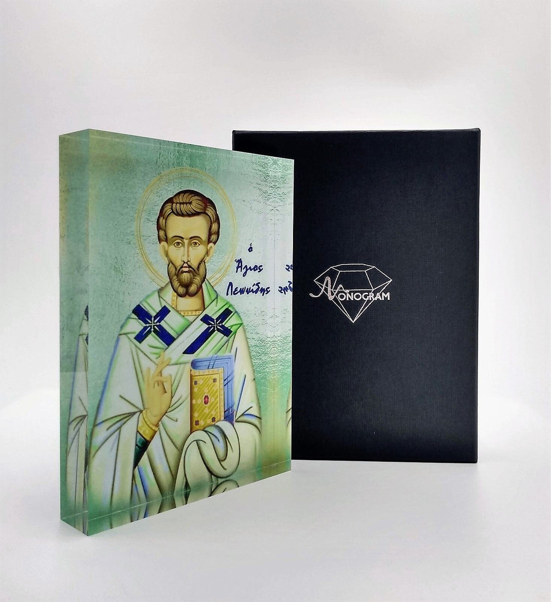 A handcrafted icon depicting Saint Leonidas, with a 3D effect, presented in front of a black background. The icon is housed in a black box with a clear display front, branded with 'Nostalgia'.