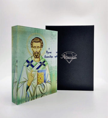 A handcrafted icon depicting Saint Leonidas, with a 3D effect, presented in front of a black background. The icon is housed in a black box with a clear display front, branded with 'Nostalgia'.
