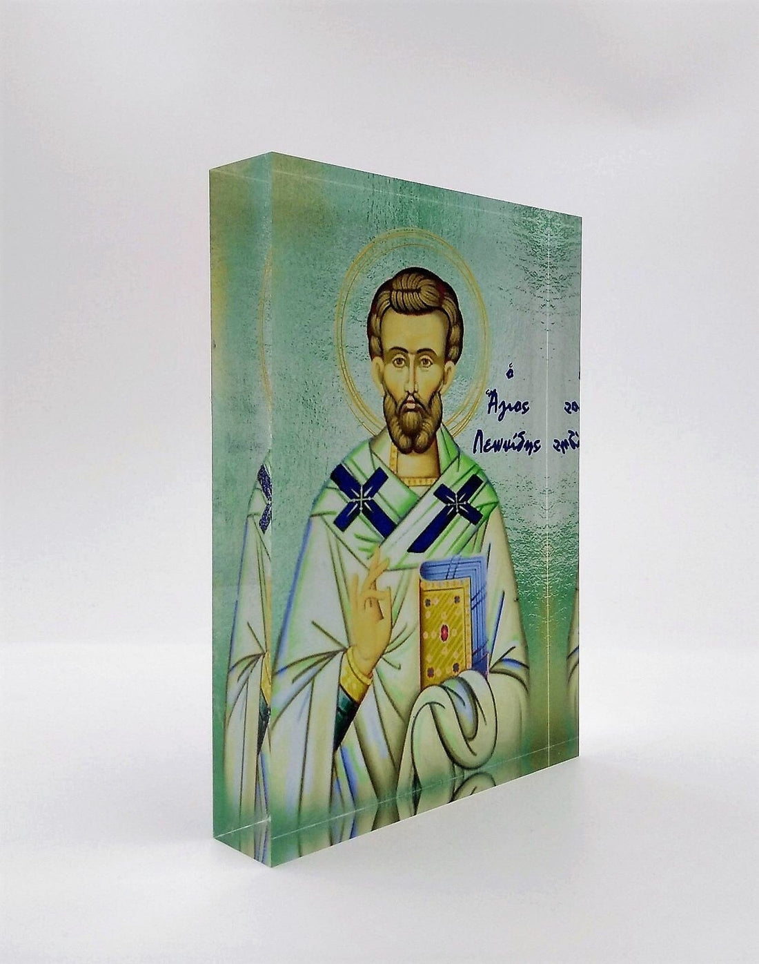 A handcrafted icon depicting Saint Leonidas, with a 3D effect, presented in front of a black background. The icon is housed in a black box with a clear display front, branded with 'Nostalgia'.