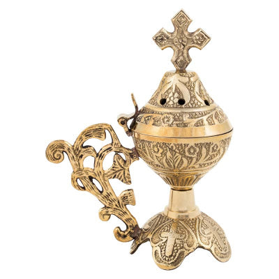 Decorative gold incense burner with cross on a white background