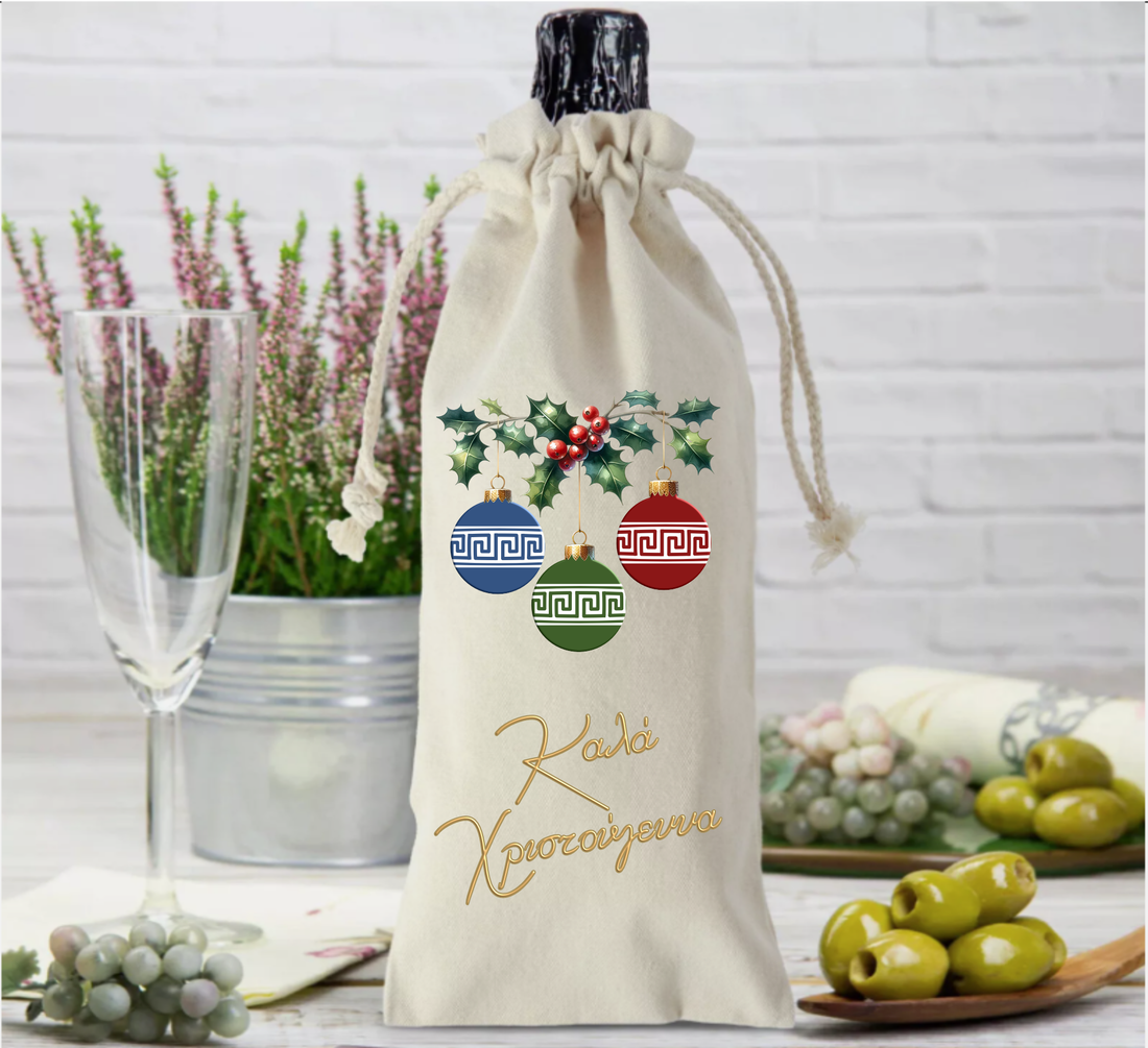 A beige fabric bottle bag with a Christmas themed graphic, including a red car, Christmas tree, and festive decorations, placed on a table with a glass of wine and some olives in the background.