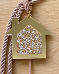 Gold acrylic house gouri lucky charm with rhinestones, white tassel and 2026 charm