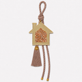 Gold acrylic house gouri lucky charm with gold and pink rhinestones, mocha cord and tassel