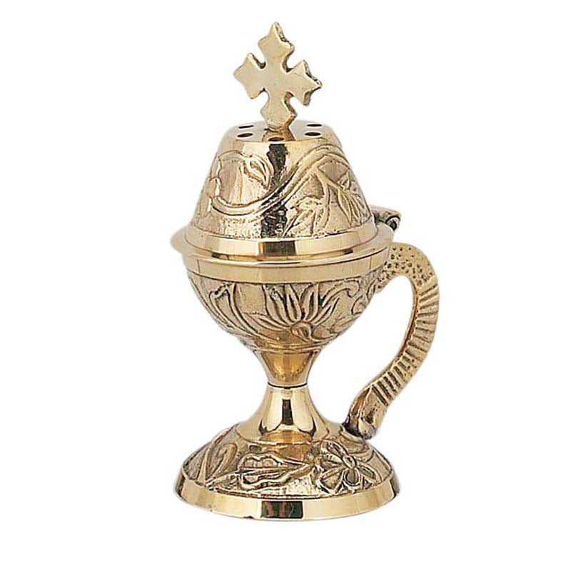 Gold incense burner with cross on a white background