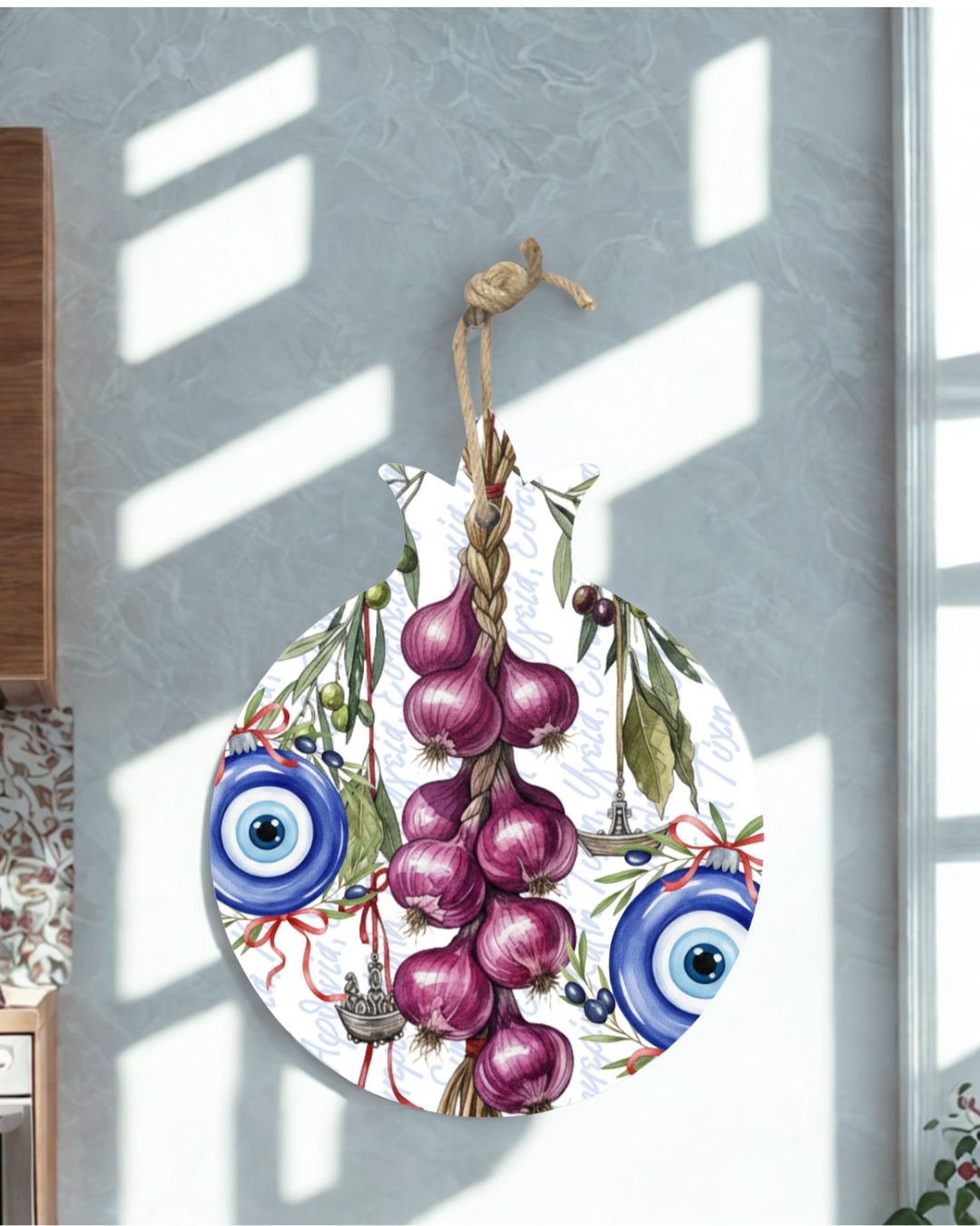 Decorative hanging ornament with pomegranate, blue evil eye, and red ball on a white background