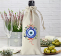 Drawstring bottle bag with an evil eye design.