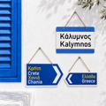 Original Greek metal street signs by Miss Ble Blu showing three styles: rectangular Kalymnos sign, double arrow Crete Chania sign, and single arrow Greece sign