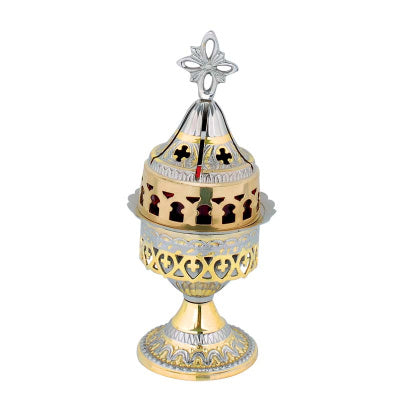 Decorative brass vigil lamp with intricate designs on a white background