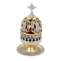 Decorative object with gold and silver elements on a white background