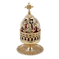 Decorative gold incense burner with intricate designs on a white background