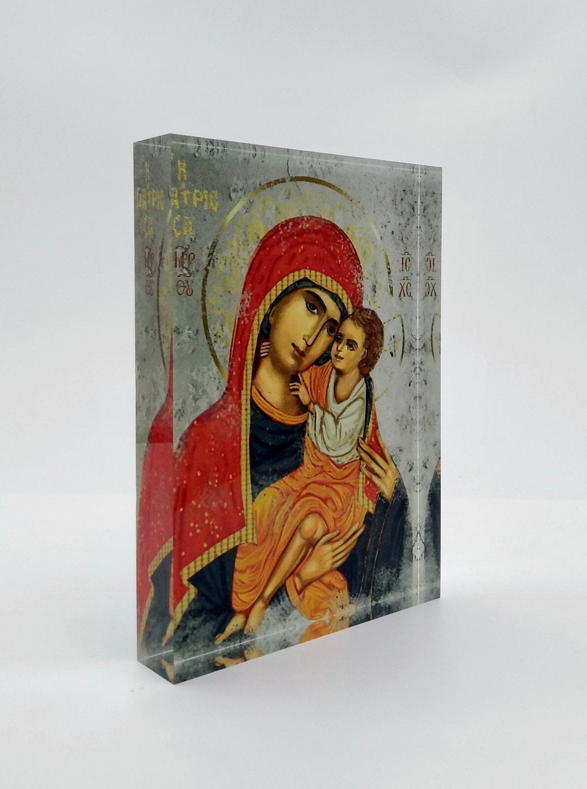 Side-angled view of the Panayia Giatrissa plexiglass icon, showing the Theotokos embracing Christ in warm healing colours. Handmade Greek Orthodox icon.