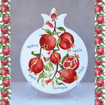 A ceramic decorative plaque featuring a pomegranate tree with red and yellow fruits, and Greek text, used as a trivet or pot stand. Personalised Decorative Plaque Pomegranate - Greek inspirational wall plaque, home or office decor
