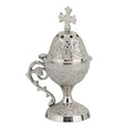 Silver incense burner with intricate designs and a cross on a white background