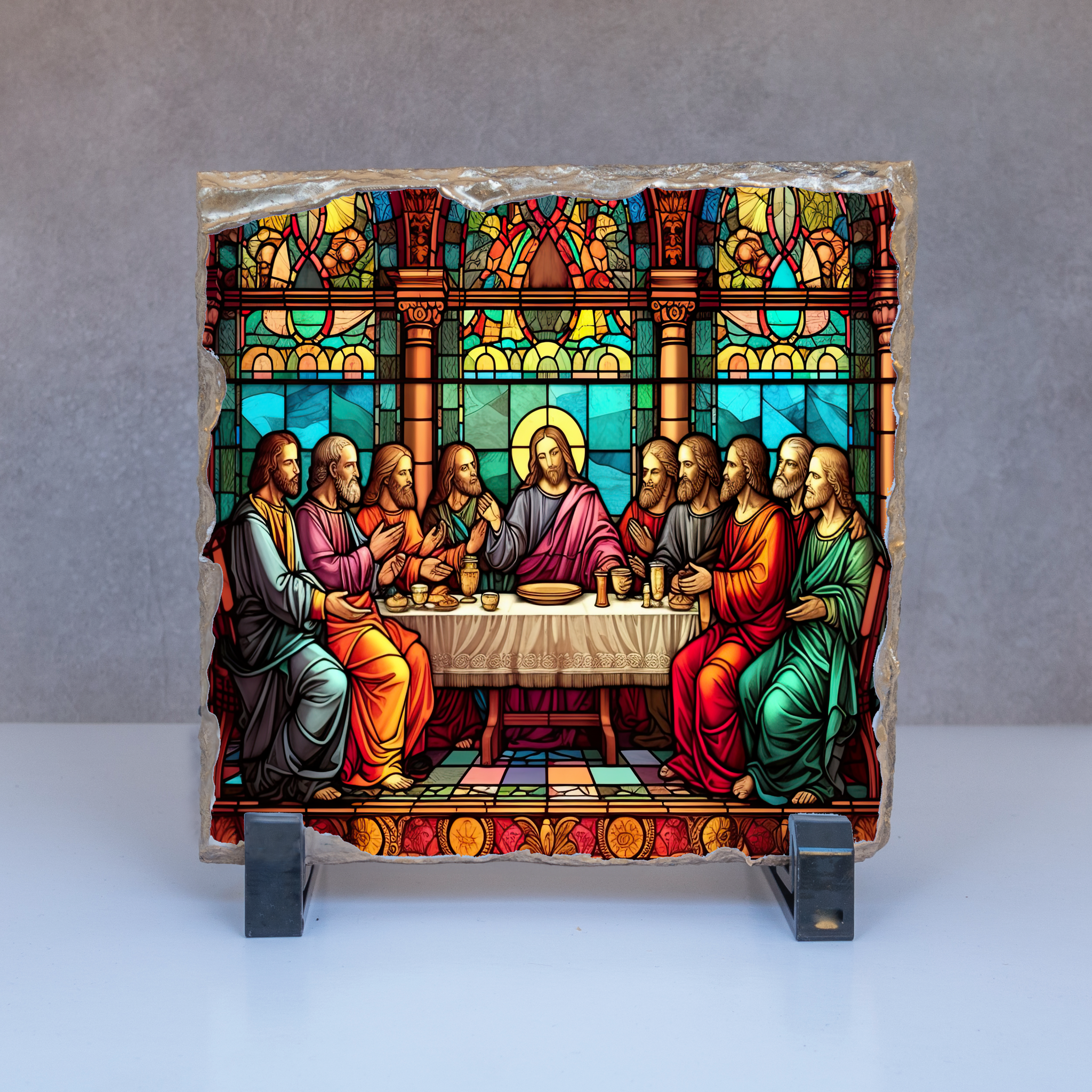 Stained glass depiction of a religious scene with figures around a table on a gray background.
