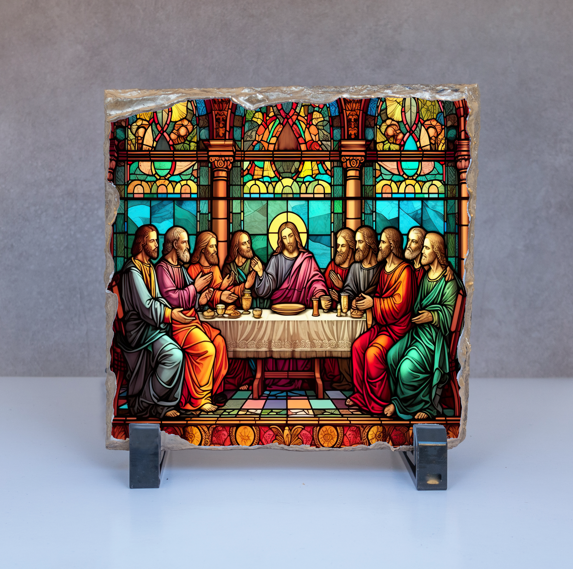 Stained glass depiction of a religious scene with figures around a table on a gray background.