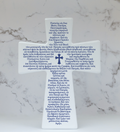 A ceramic cross with a glossy finish, featuring the Greek text for 'The Creed of Faith' inscribed on it, displayed against a marble background.