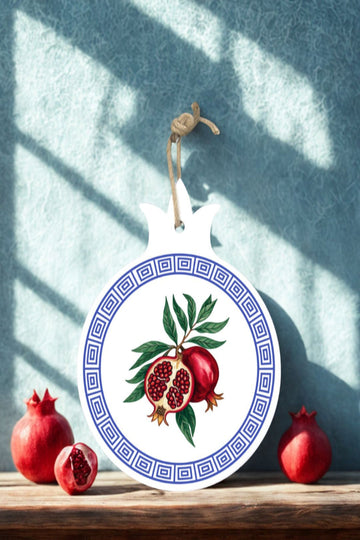 Greek-inspired ceramic hot plate stand used for serving hot cookware on a countertop.