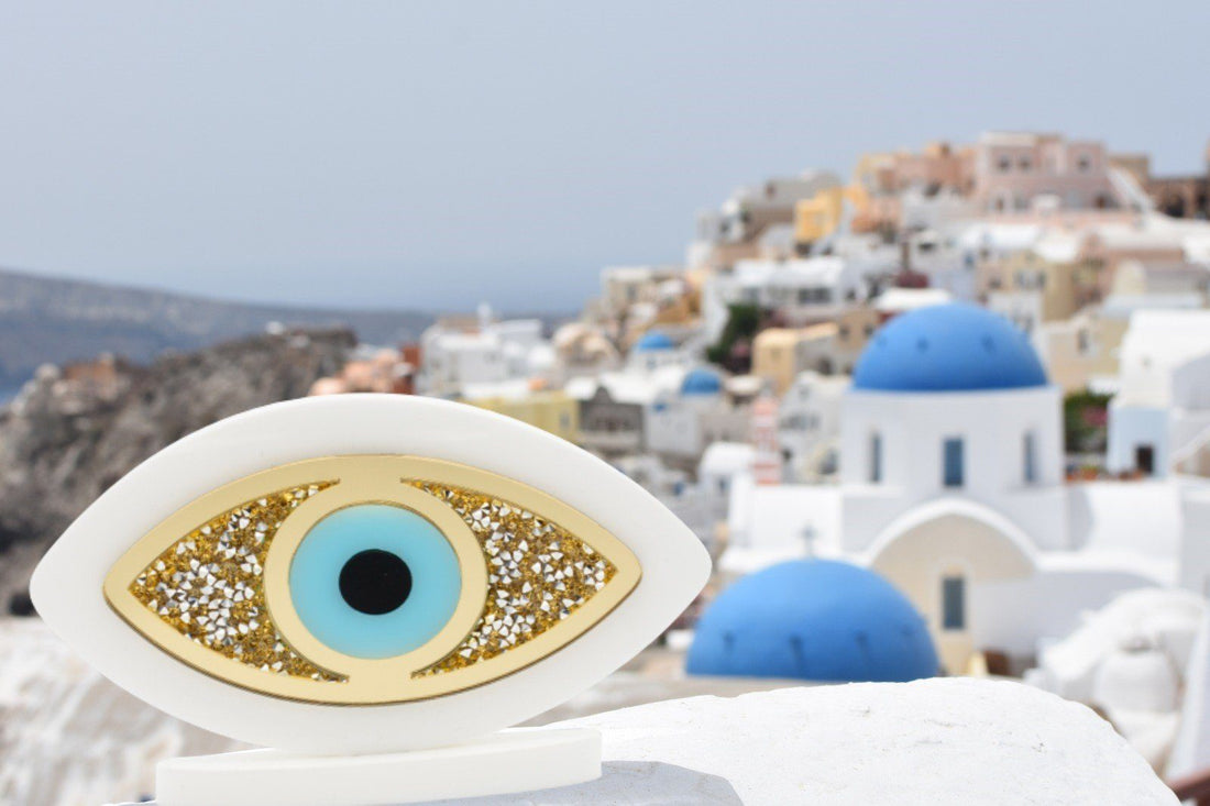 Acrylic plexiglass Evil Eye (Mati) home décor piece decorated with gold and silver rhinestones.