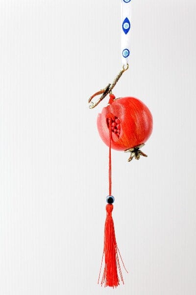 Greek pomegranate gouri lucky charm boxed with ribbon and Greek wishes.
