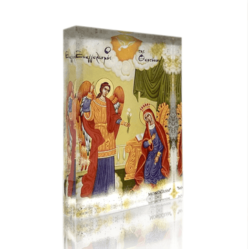 A religious icon depicting the Annunciation of the Theotokos, with vibrant colors and gold accents, packaged in a plexiglass case.