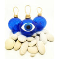 Hand blown glass baubles in blue with a mati design, or an evil eye.  