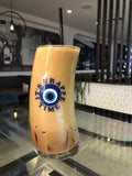 Original Wave Frappe Glass with It’s Frappe Time evil eye design, filled with iced Greek frappe at a café