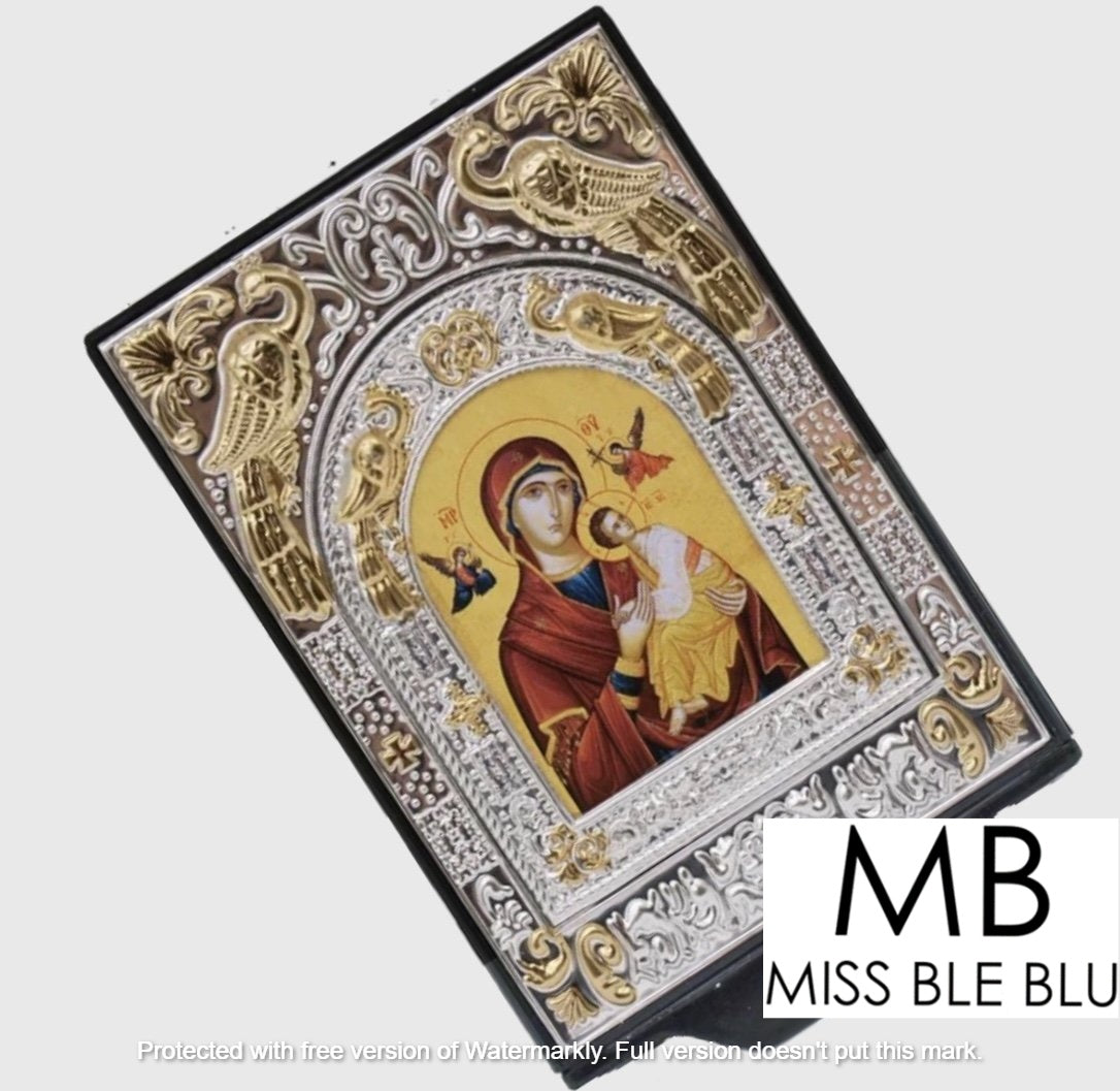 A decorative icon box with a colorful religious icon depicting the Virgin Mary and child Jesus, surrounded by a silver ornate frame.