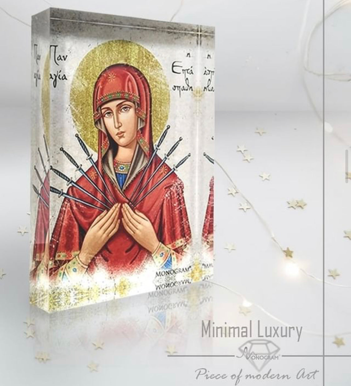 Plexiglass icon of Panayia Eptaspathi with seven swords, shown upright in a styled setting with light background. Handmade Greek Orthodox icon by Monogram Atelier.