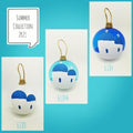 Santorini Greek glass Christmas bauble collection showing multiple blue and clear handmade ornament designs